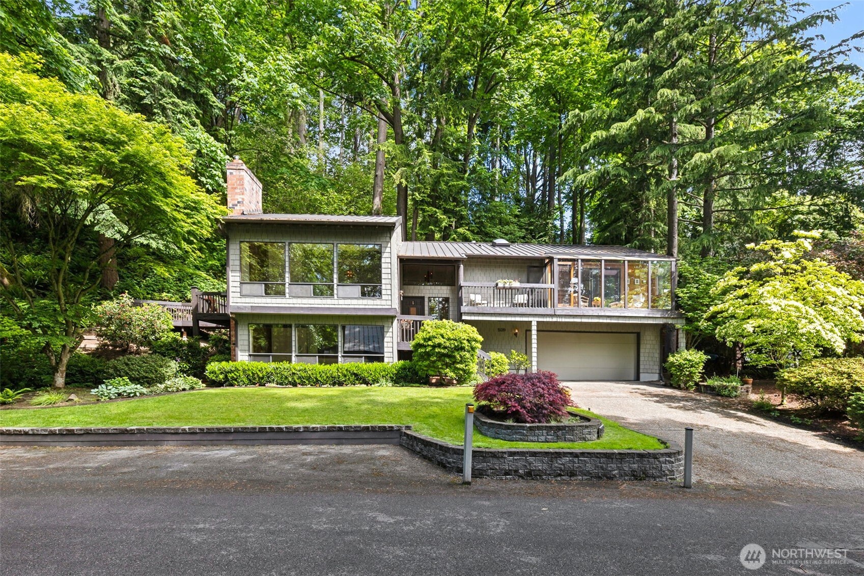 5019 East Mercer Way Mercer Island, WA 98040 - Photo 1 of 31 a front view of a house with garden
