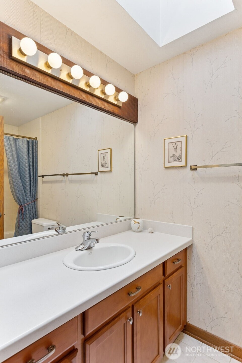 5019 East Mercer Way Mercer Island, WA 98040 - Photo 17 of 31 a bathroom with a sink and a mirror