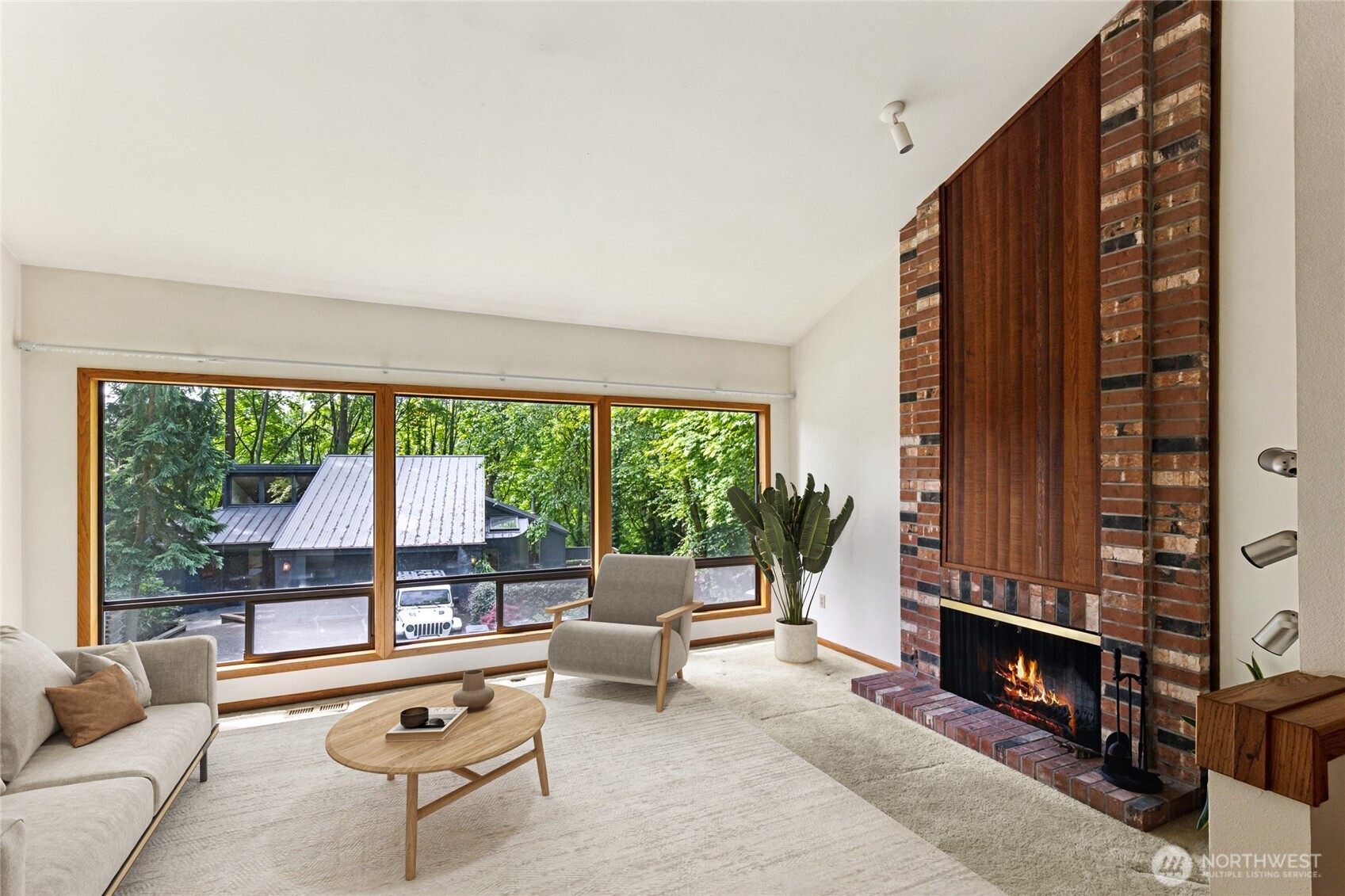 5019 East Mercer Way Mercer Island, WA 98040 - Photo 2 of 31 a living room with fireplace furniture and a large window