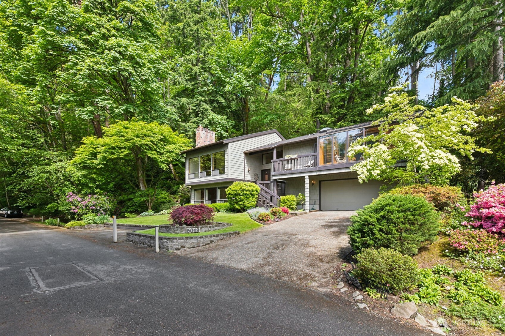 5019 East Mercer Way Mercer Island, WA 98040 - Photo 29 of 31 a front view of a house with a yard and garage