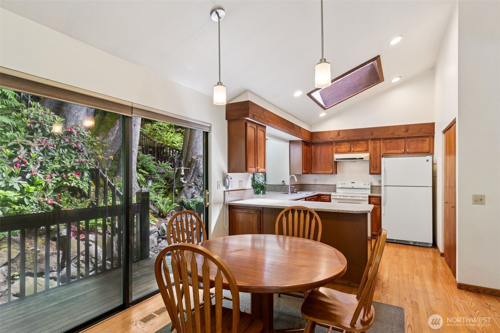 5019 East Mercer Way Mercer Island, WA 98040 - Photo 7 of 31 a dining room with furniture a chandelier and wooden floor