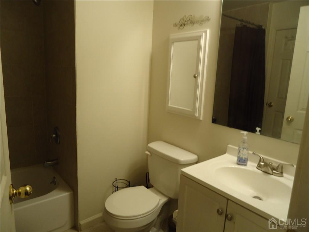 831 Edpas Road, Unit 831 New Brunswick, NJ 08901 - Photo 10 of 15 a bathroom with a sink a toilet and shower