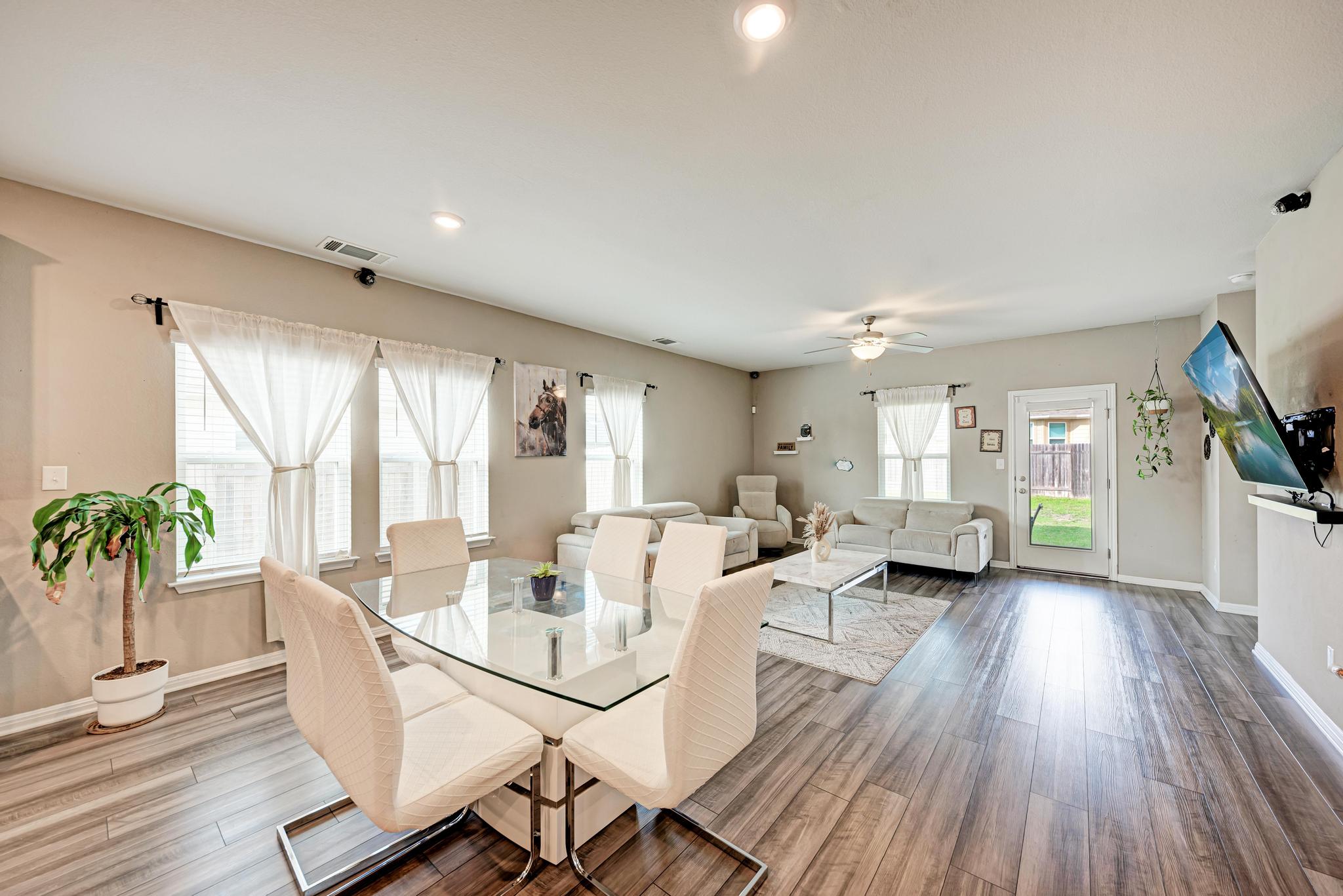 305 Windy Reed Road Hutto, TX 78634 - Photo 35 of 35 An open floor plan seamlessly connects the dining area to the bright living space.