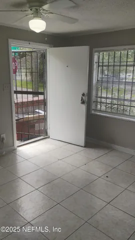 a view of an empty room with a window