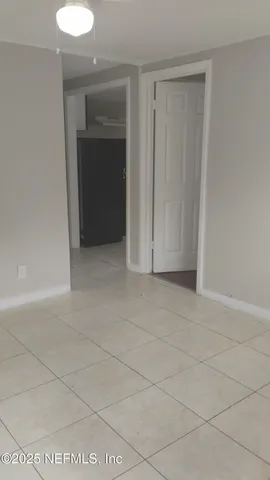 a view of an empty room and closet area