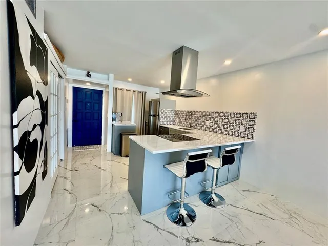 a view of a kitchen with kitchen island dining table and chairs