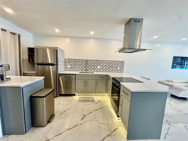 a kitchen with a sink stove and refrigerator