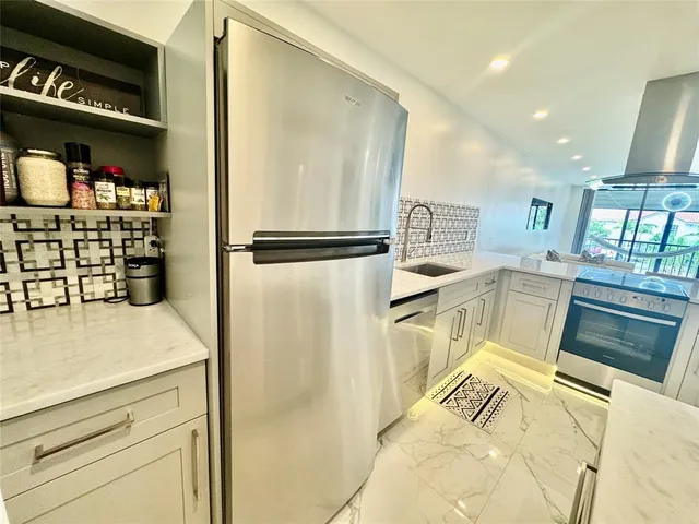 a kitchen with stainless steel appliances a refrigerator and a stove