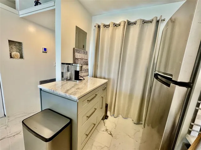 a bathroom with sink a mirror a vanity and a shower