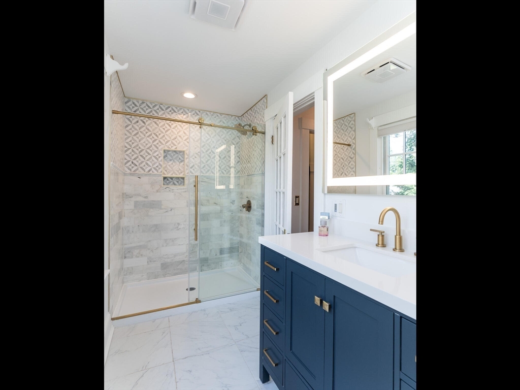 48 Hillcrest Avenue Longmeadow, MA 01106 - Photo 22 of 42 a bathroom with a granite countertop sink a mirror a shower and a bathtub