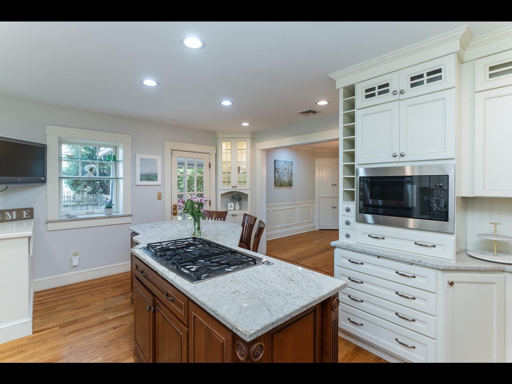 48 Hillcrest Avenue Longmeadow, MA 01106 - Photo 8 of 42 a kitchen with stainless steel appliances kitchen island granite countertop a stove a sink and a microwave