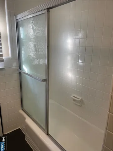 a bathroom with a glass shower door