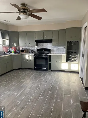 a kitchen with a sink a stove and cabinets