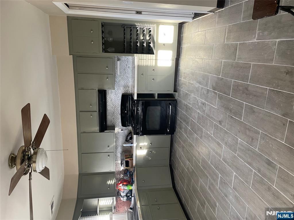 113 Hawthorne Avenue Hawthorne, NJ 07506 - Photo 15 of 19 a kitchen with a sink a stove and cabinets