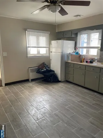 a kitchen with refrigerator and window