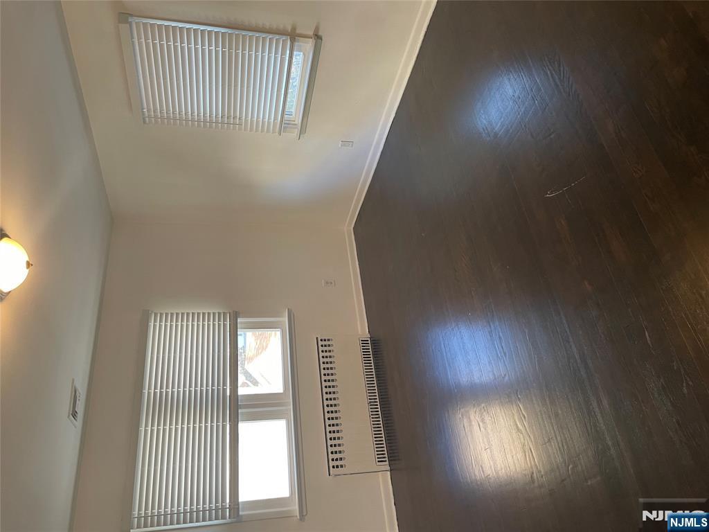 113 Hawthorne Avenue Hawthorne, NJ 07506 - Photo 17 of 19 a view of an empty room with wooden floor and a window