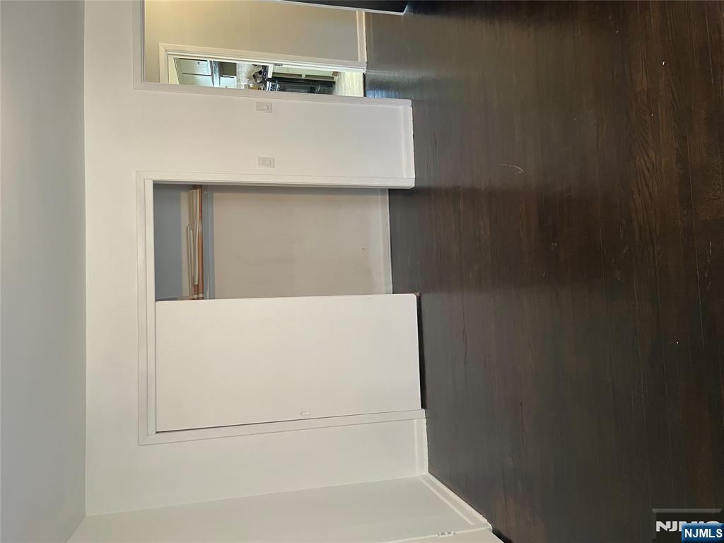 113 Hawthorne Avenue Hawthorne, NJ 07506 - Photo 18 of 19 a view of an empty room with wooden floor and closet