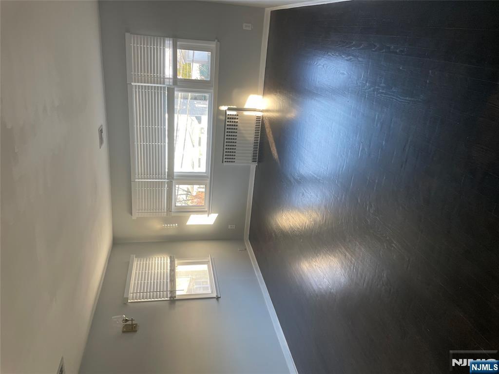 113 Hawthorne Avenue Hawthorne, NJ 07506 - Photo 2 of 19 an empty room with wooden floor and windows