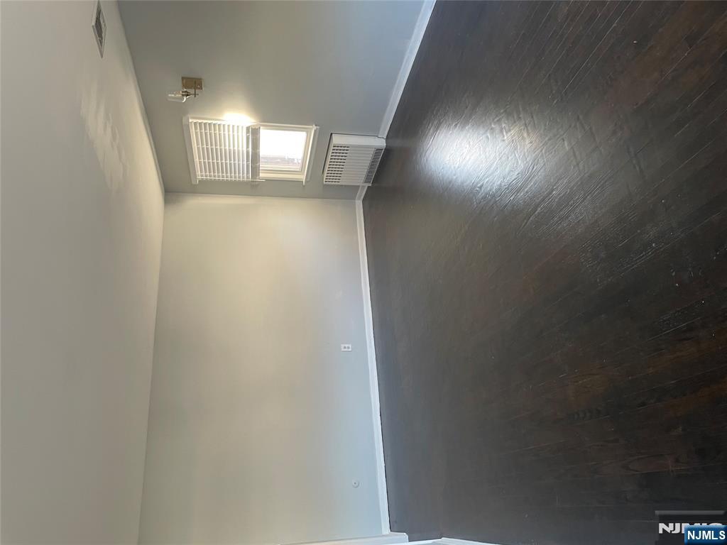 113 Hawthorne Avenue Hawthorne, NJ 07506 - Photo 3 of 19 an empty room with wooden floor and windows
