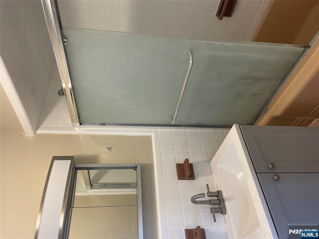 113 Hawthorne Avenue Hawthorne, NJ 07506 - Photo 5 of 19 a bathroom with a sink and mirror