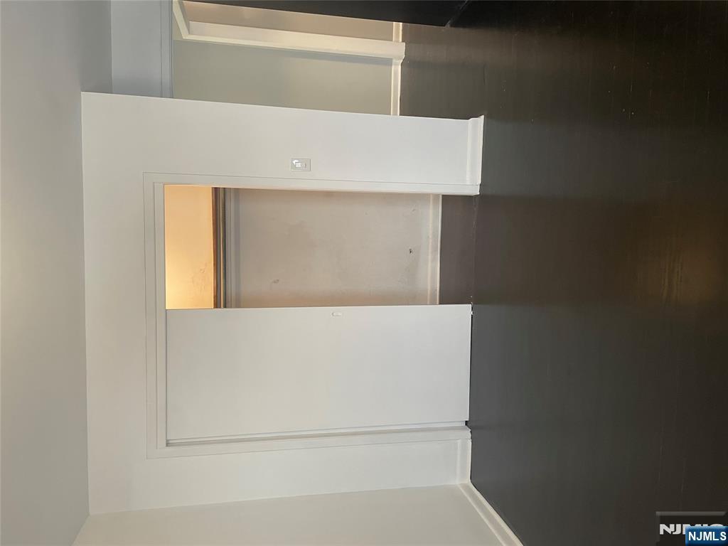 113 Hawthorne Avenue Hawthorne, NJ 07506 - Photo 10 of 19 a view of an empty room with wooden floor and a window