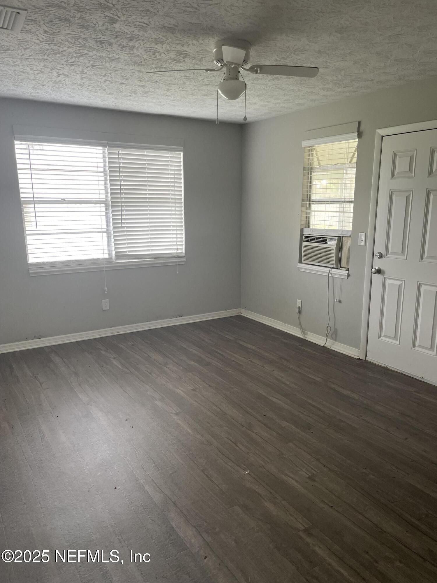 130 Gassett Road St. Augustine, FL 32080 - Photo 5 of 15 an empty room with wooden floor and windows