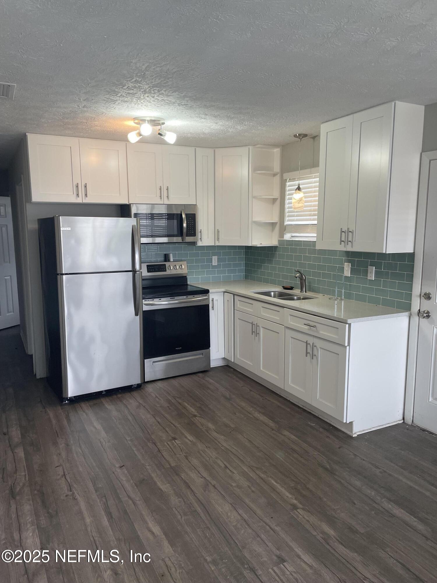 130 Gassett Road St. Augustine, FL 32080 - Photo 7 of 15 a kitchen with stainless steel appliances a refrigerator sink and microwave