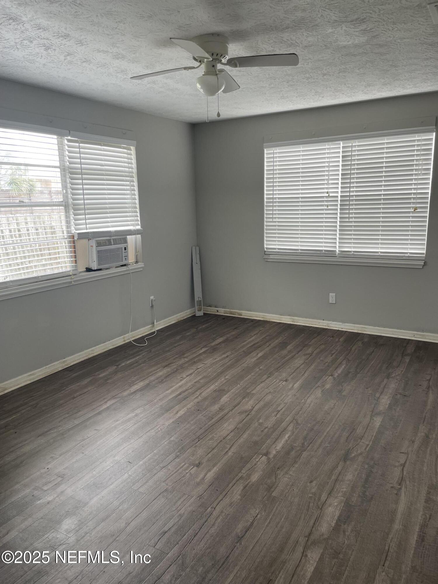 130 Gassett Road St. Augustine, FL 32080 - Photo 8 of 15 an empty room with wooden floor and windows