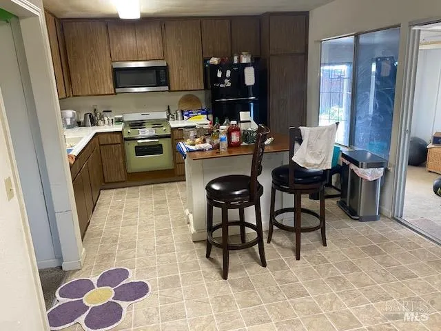 a kitchen with a sink cabinets and a stove top oven