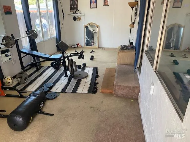 a view of gym equipment and floor to ceiling window