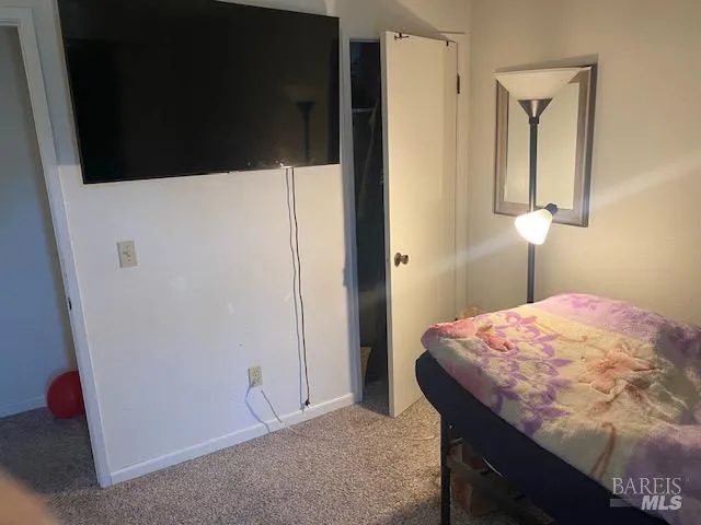 a bedroom with a bed and a cabinet