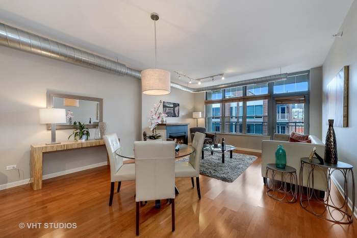 1200 West Monroe Street, Unit 502 Chicago, IL 60607 - Photo 8 of 20 a view of a dining room with furniture window and wooden floor