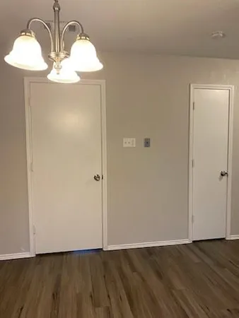 a kitchen with granite countertop white cabinets and sink