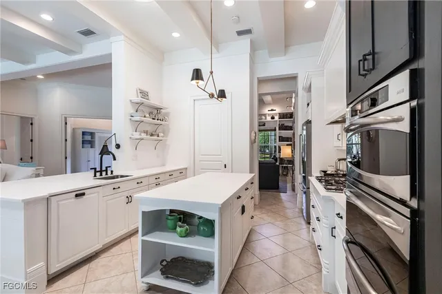 a kitchen with a sink refrigerator and cabinets