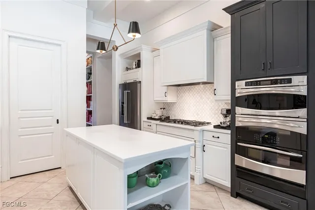 a kitchen with stainless steel appliances a stove a microwave and cabinets