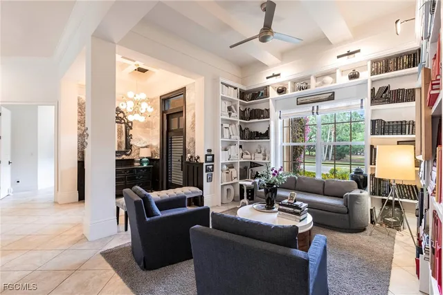 a living room with furniture potted plant and a large window