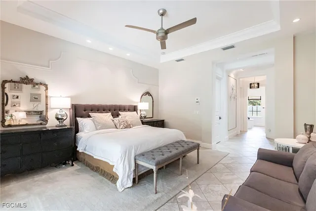 a bedroom with a bed couch and window