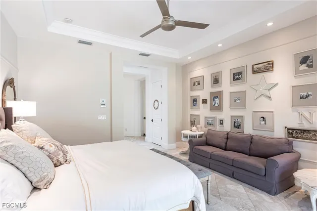 a bedroom with a bed furniture and a chandelier