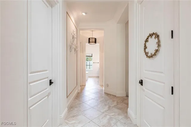 a view of a hallway with white doors