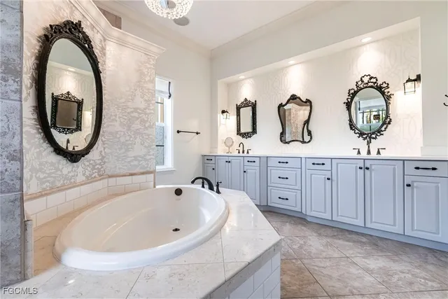 a spacious bathroom with a bathtub and a sink