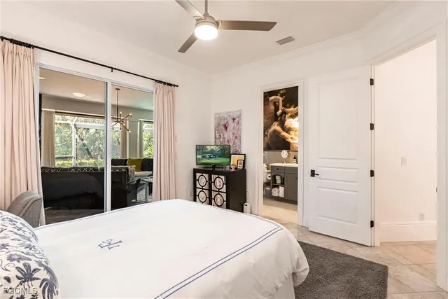 a bedroom with a large bed and a tv