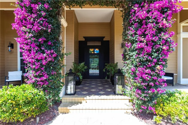 a front view of a house with a flower garden