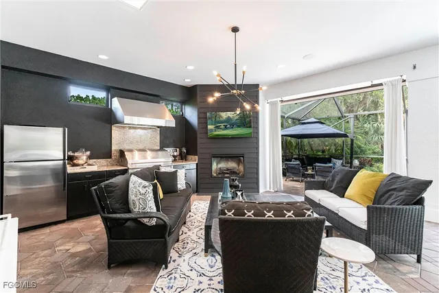 a living room with fireplace furniture and a large window