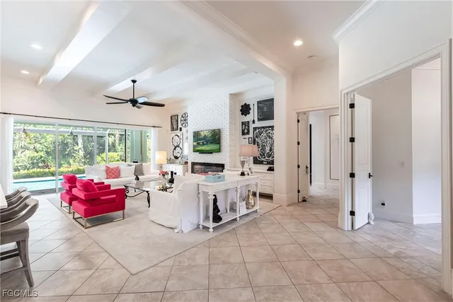 a living room with furniture and large windows