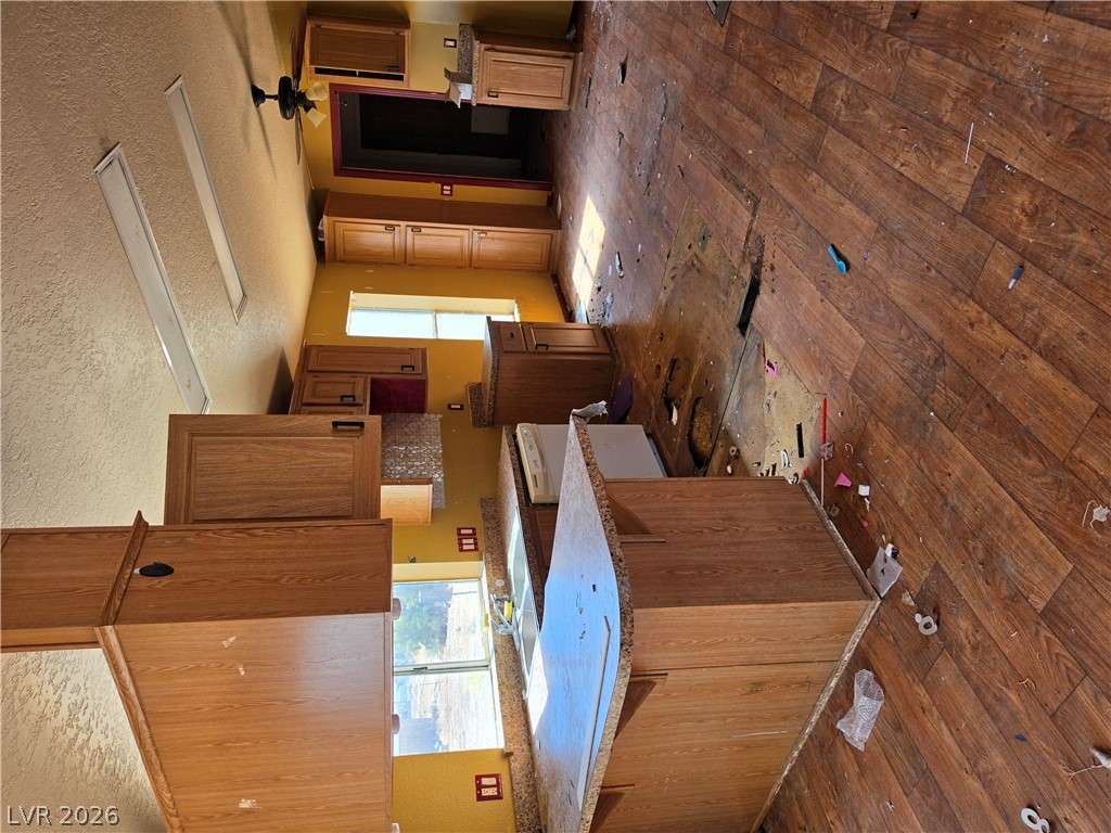 4231 West Wilson Road Pahrump, NV 89048 - Photo 5 of 19 A spacious kitchen space awaits complete renovation with its generous wooden cabinetry.