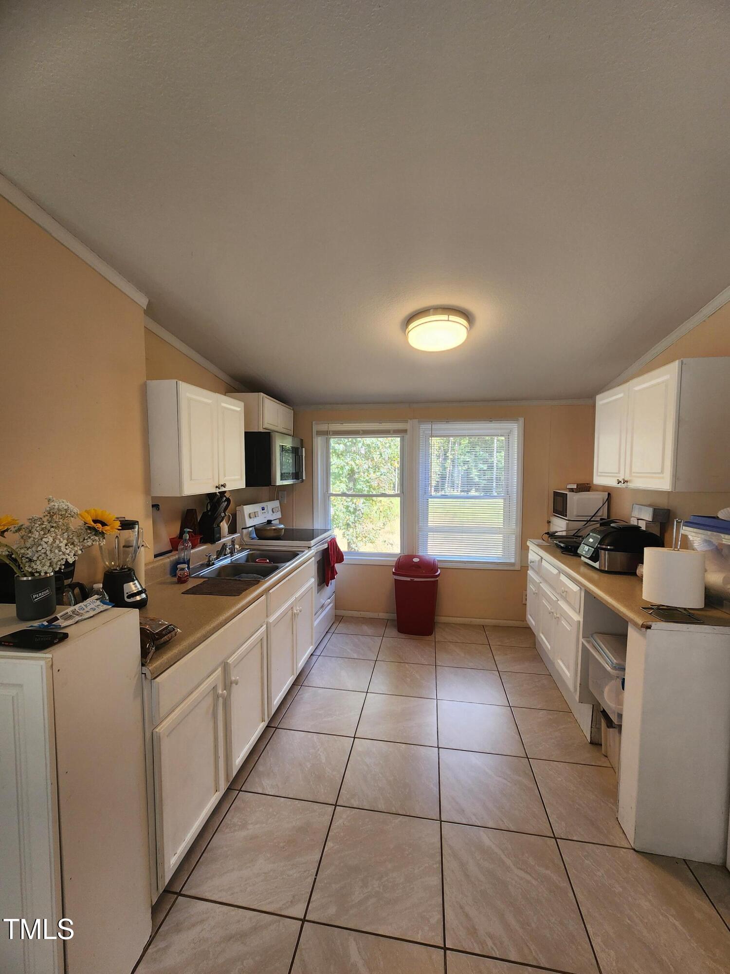 88 Barnes Road Middlesex, NC 27557 - Photo 10 of 18 a kitchen with a stove a sink and a refrigerator