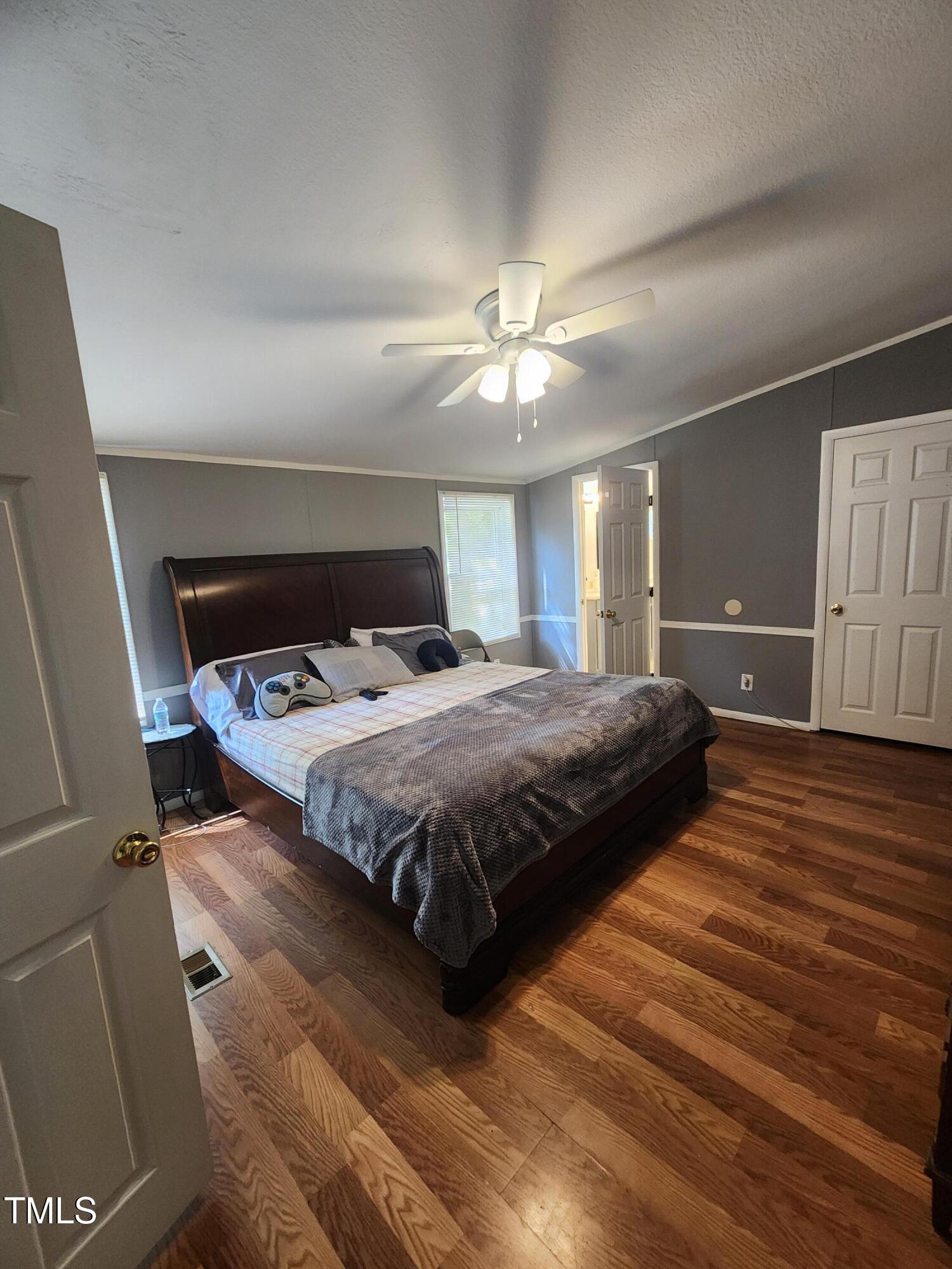 88 Barnes Road Middlesex, NC 27557 - Photo 12 of 18 a bedroom with a large bed and a chandelier