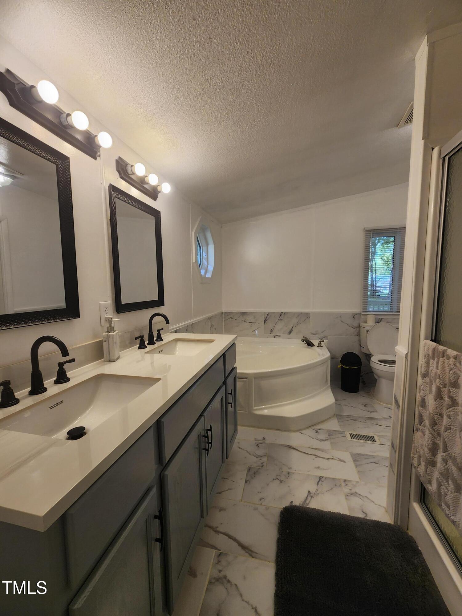 88 Barnes Road Middlesex, NC 27557 - Photo 14 of 18 a bathroom with a sink double vanity and a mirror