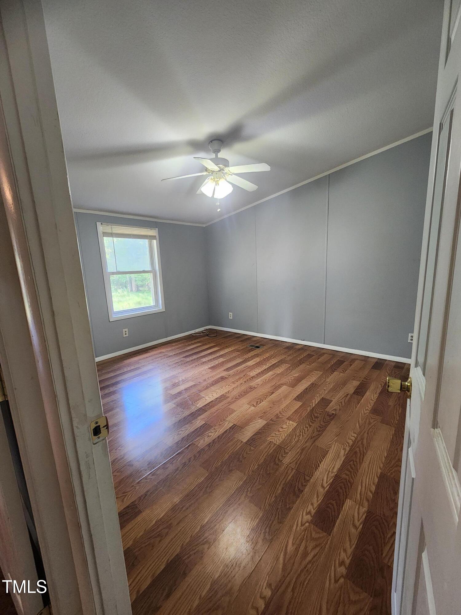 88 Barnes Road Middlesex, NC 27557 - Photo 5 of 18 an empty room with windows and fan