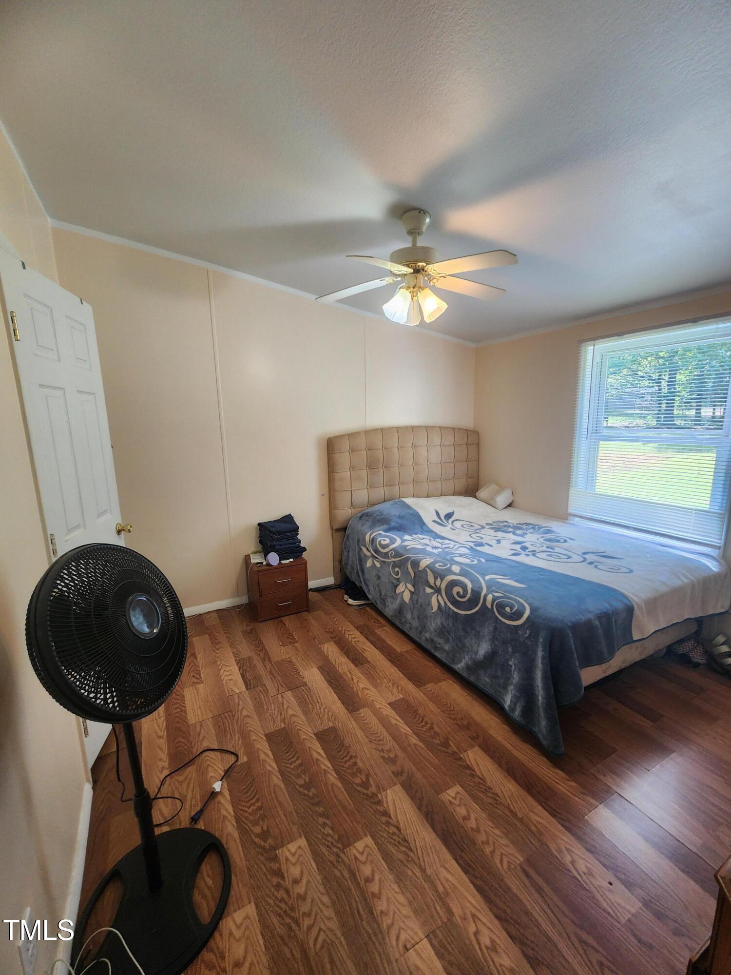 88 Barnes Road Middlesex, NC 27557 - Photo 7 of 18 a bedroom with a bed a chandelier and a fan